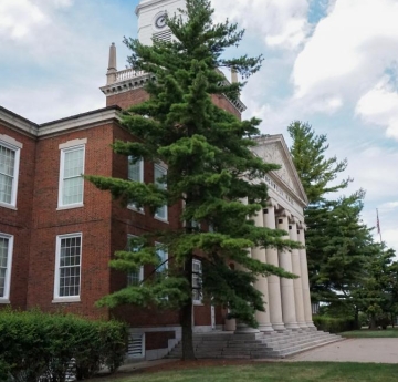 Two magnificent, gigantic eastern white pines stand tall on either side of the front entrance of Rockwell Hall.